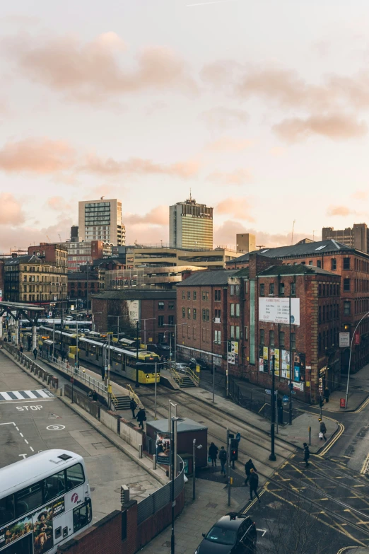 a city street filled with traffic next to tall buildings