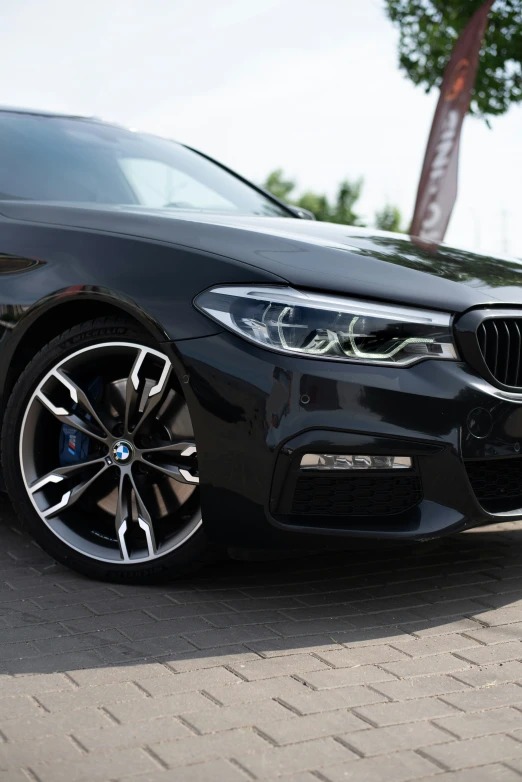 black bmw sedan parked outside of a building