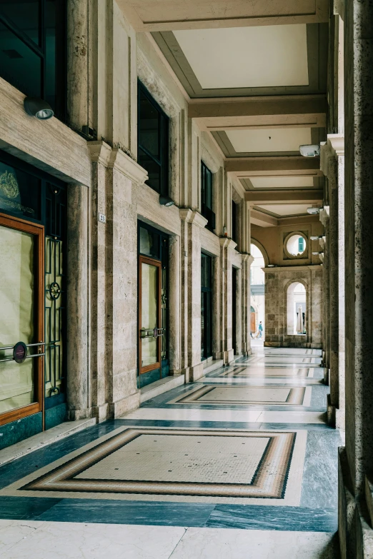 the hallway of a building that has many doors