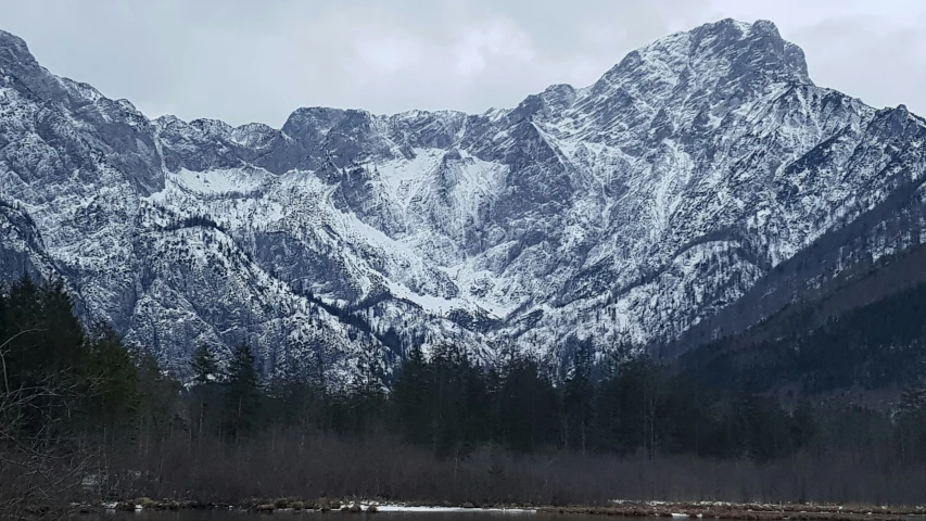 the mountain tops have snow on them in the mountains