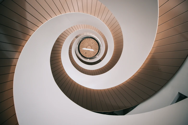 an aerial view of a spiral staircase at the end of a flight