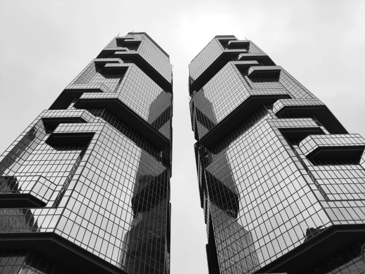 a tall building with several windows and some clouds