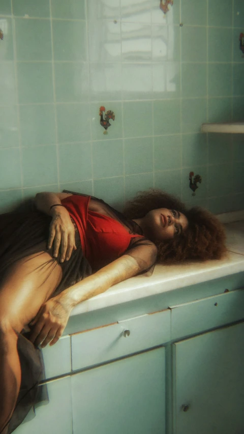 a woman lies in the bathtub with her back to the window