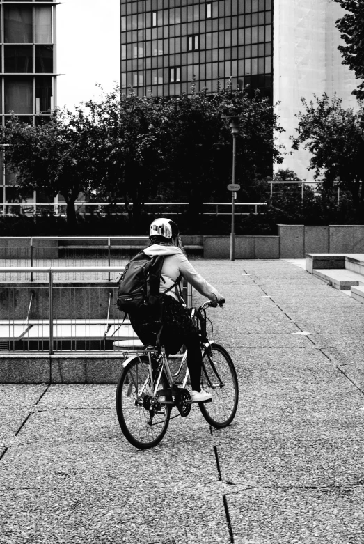 a person riding a bicycle next to some buildings