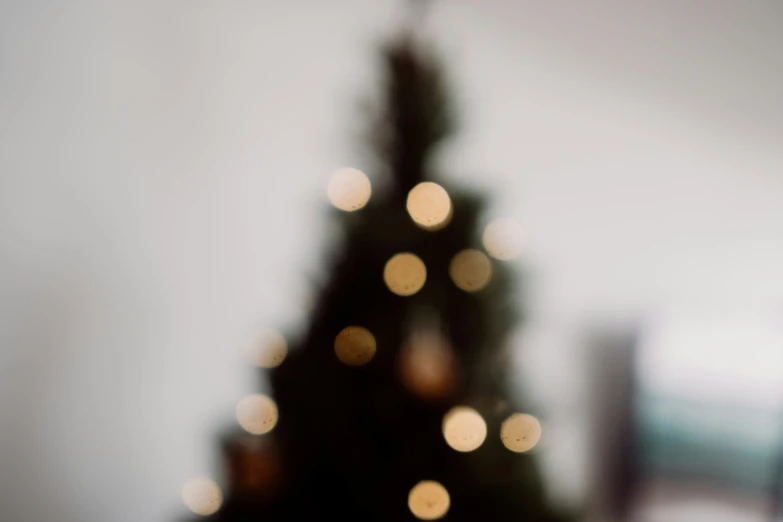 a lit up christmas tree is displayed in a blurry po