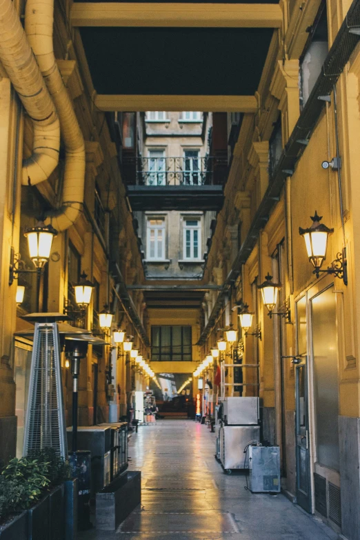 a long hallway with a large door leading to two buildings