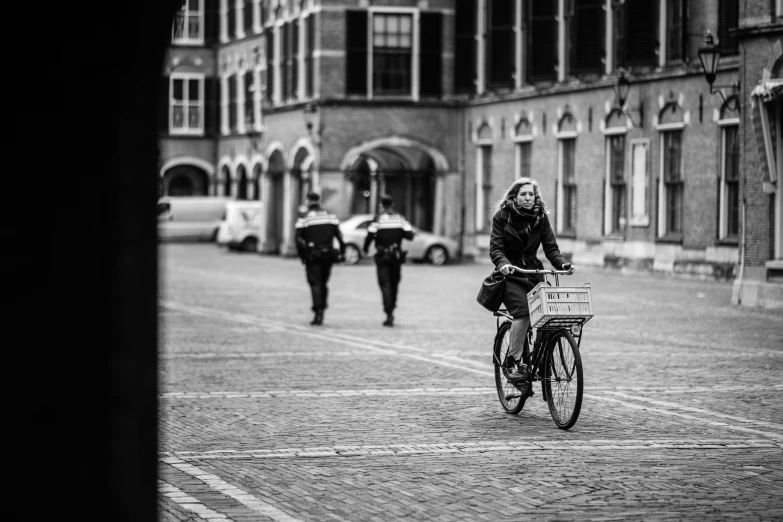 a woman on a bike on a brick road