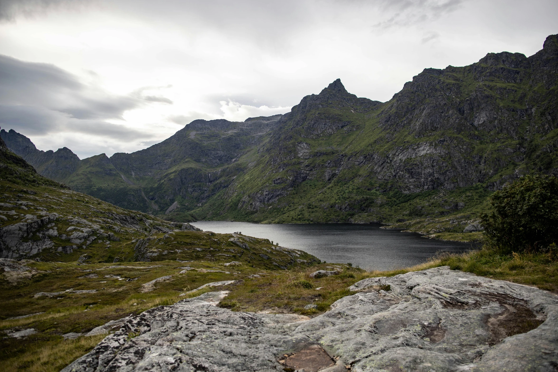 a scenic mountain view looking out across a body of water