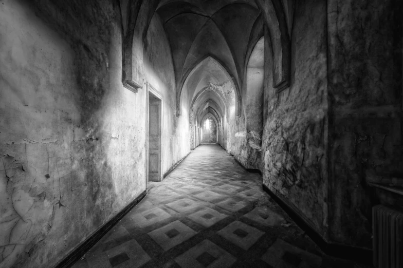 an empty alley with long stone arches