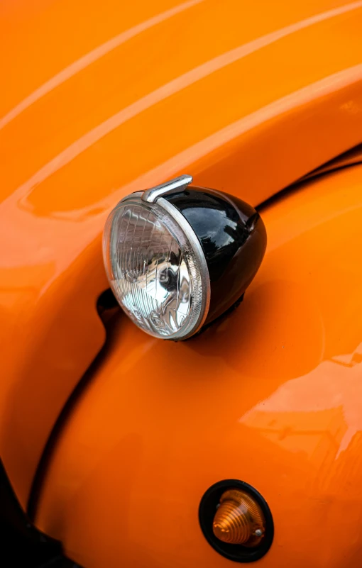 a car with its headlight showing, from the side