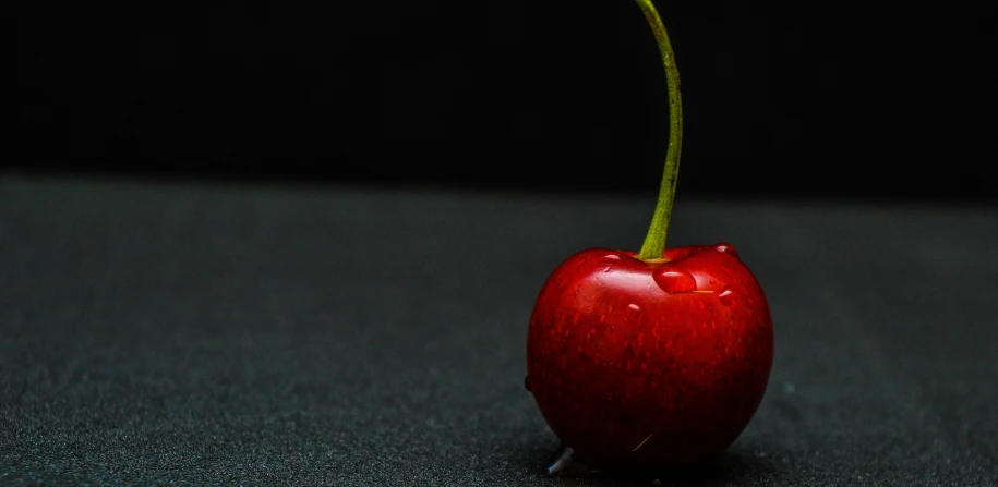 a small red apple sitting on top of a table