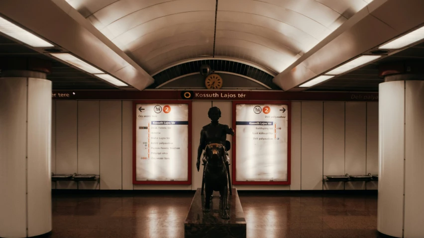 a man is standing on a train platform in the sunlight