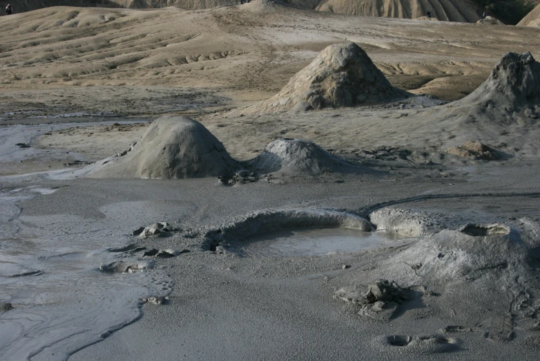 a group of mounds covered with dirt near hills