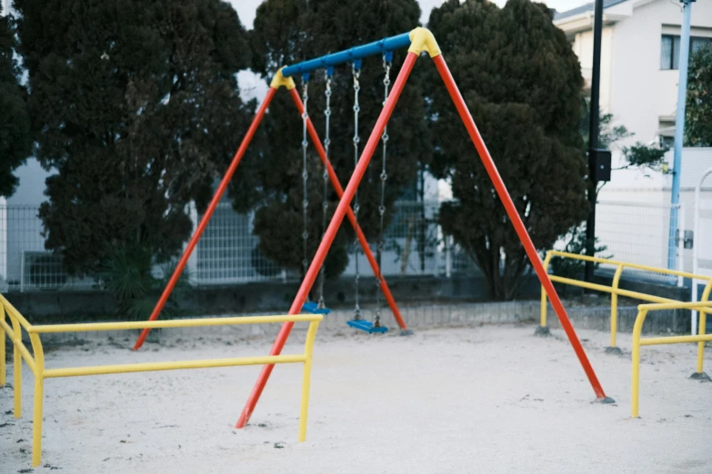 empty swings in an area in front of a building
