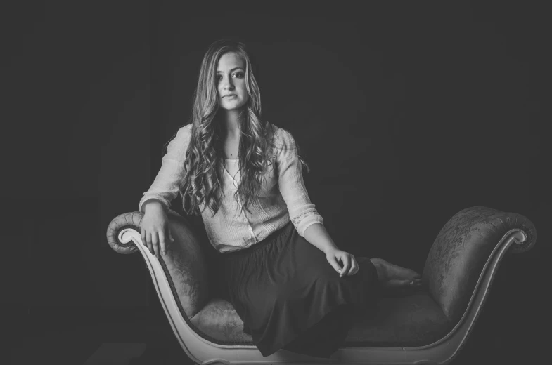 woman sitting on a couch looking down