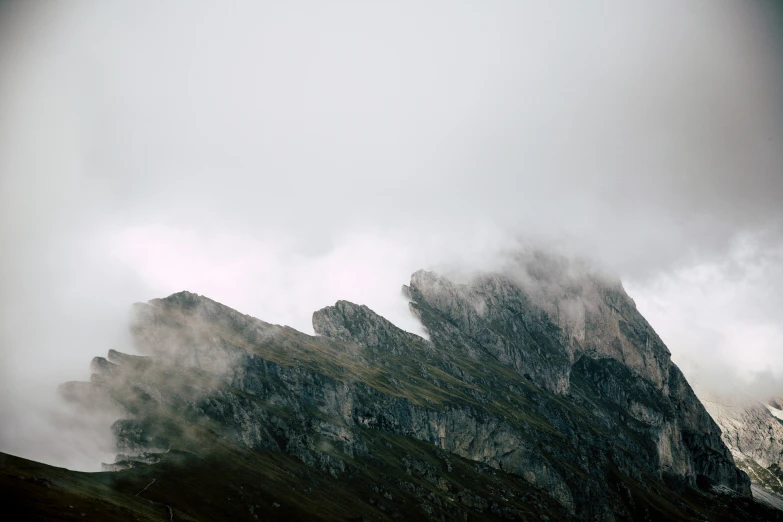 mountains and rocks are obscured by the clouds