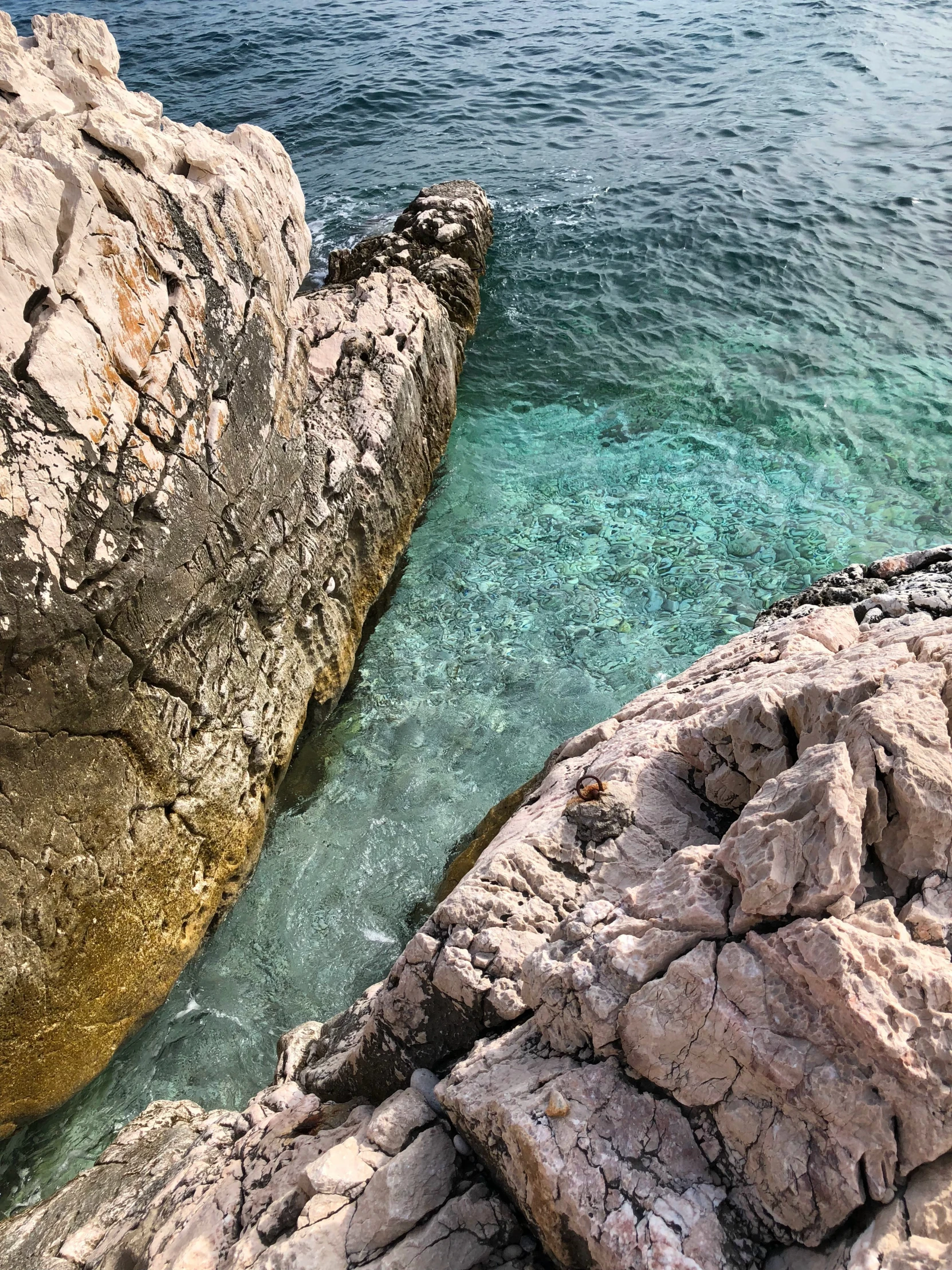 a view of a body of water between large rocks