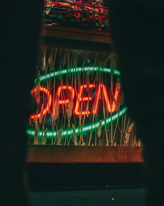 an illuminated sign hanging from the side of a building