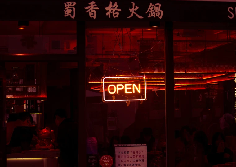a neon sign above the entrance of a restaurant
