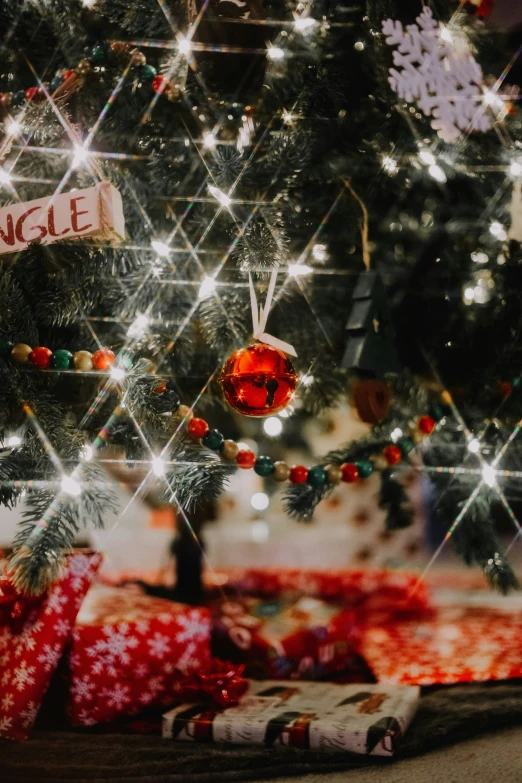 presents are scattered around the christmas tree as a display