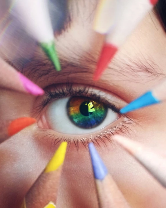 a person holding a few pencils in their eye