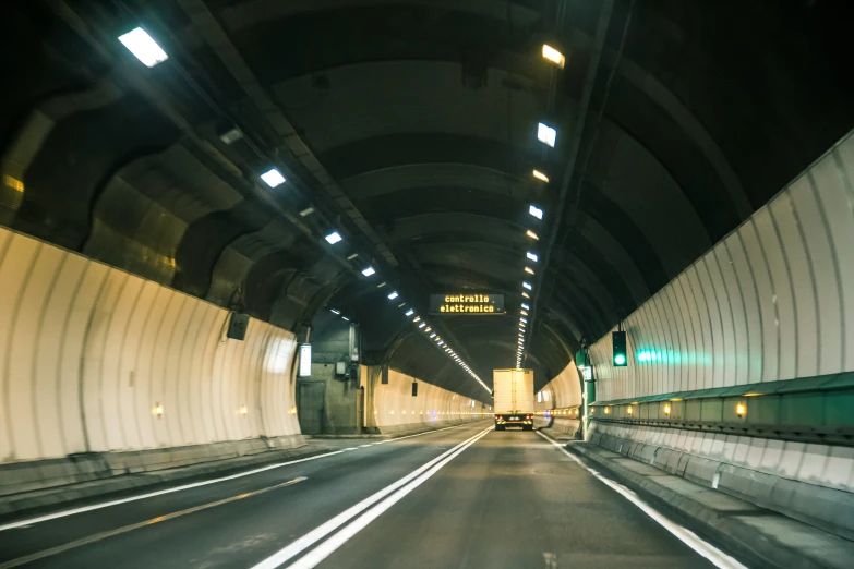 a car traveling through an underground tunnel with lights