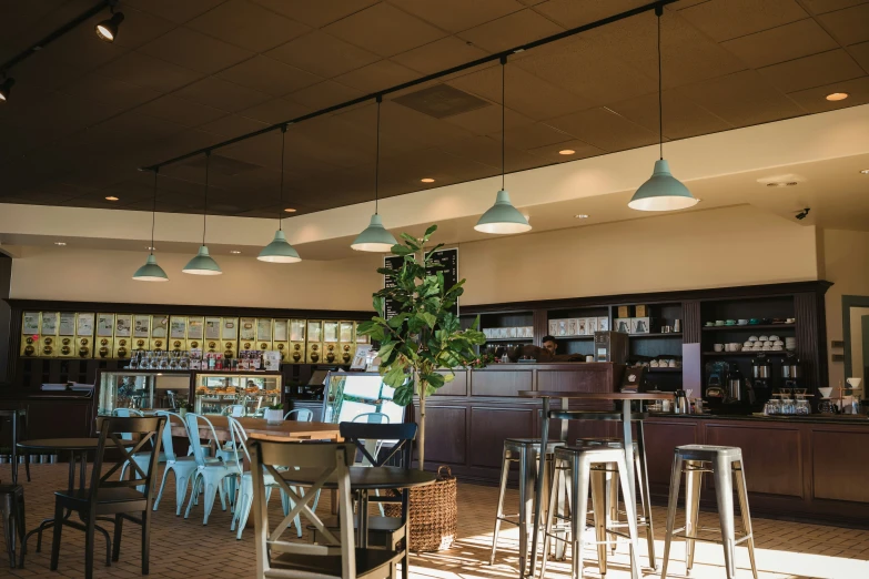 a view of a restaurant's bar with various chairs, and tables