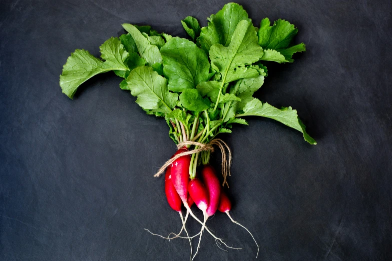 a bunch of beets with leaves and roots are shown