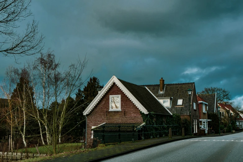 a cloudy sky over several brick houses