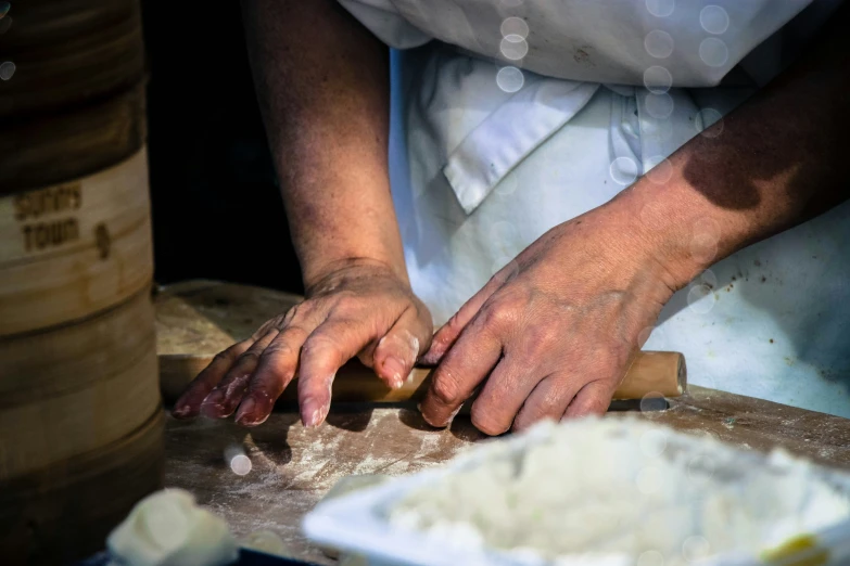 a person  food into smaller portions with their hands