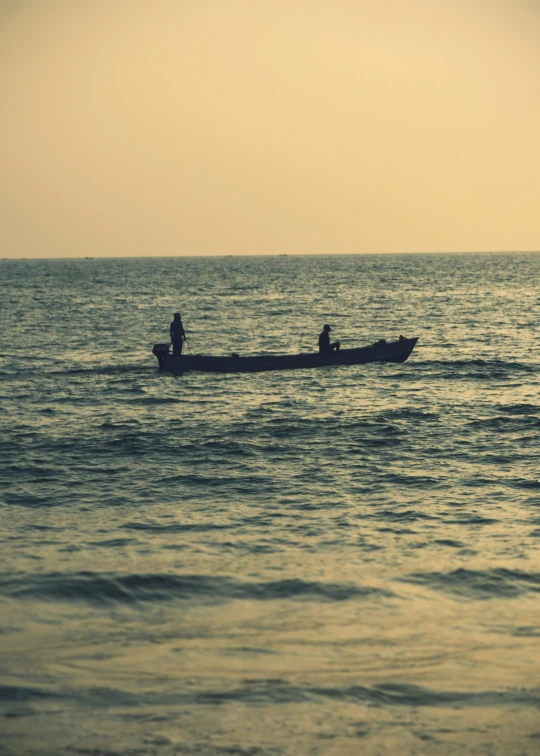 two people in a small boat are out on the ocean