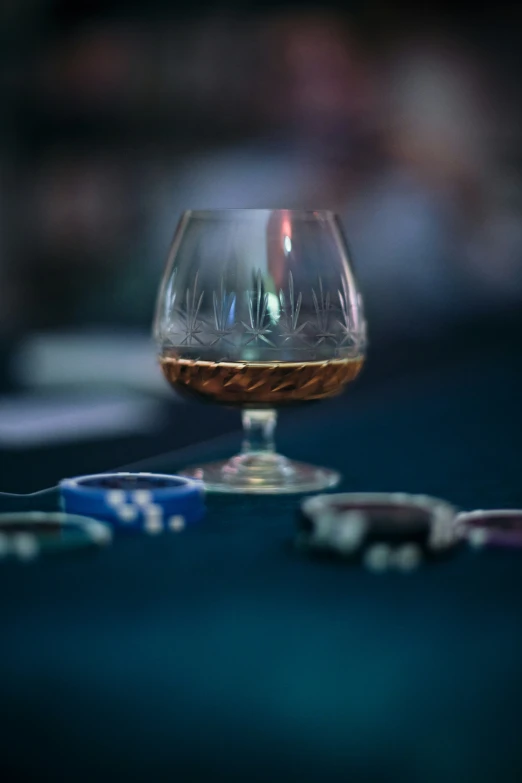 a half empty glass sitting next to an electric guitar