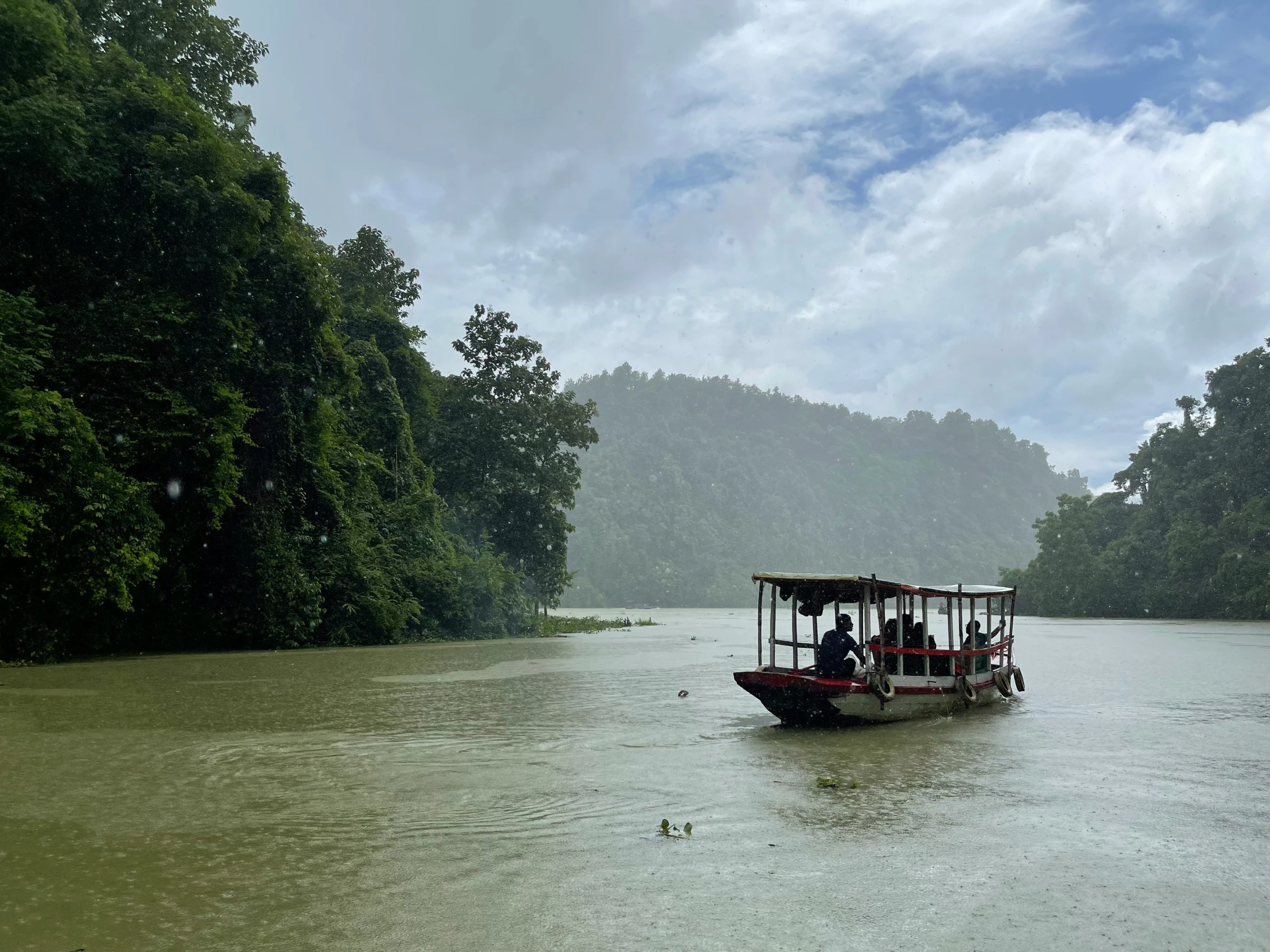 people are riding in the boat down the river