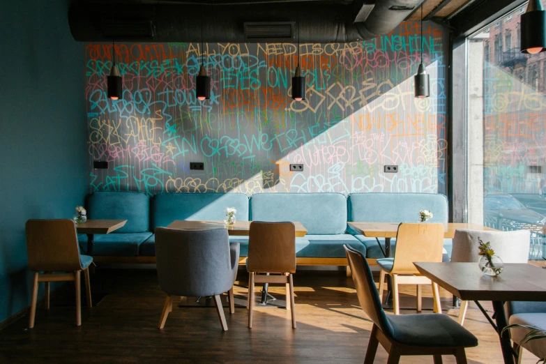 a coffee shop with painted walls and blue couches