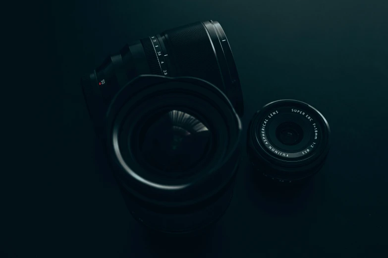 a camera on a table with the lens up to its flash speed