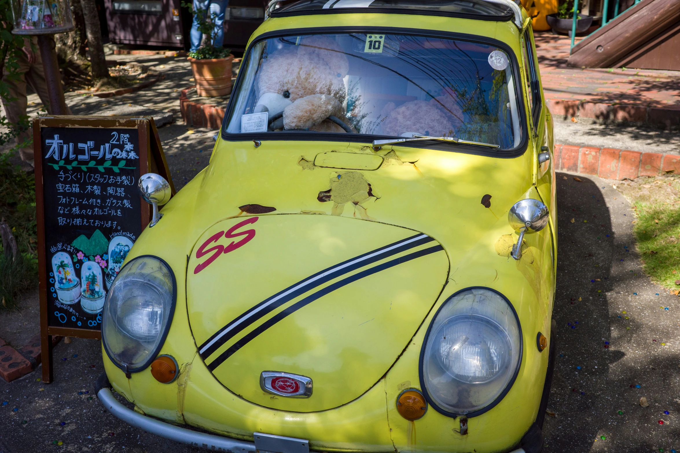 the dog is in the yellow vw bug