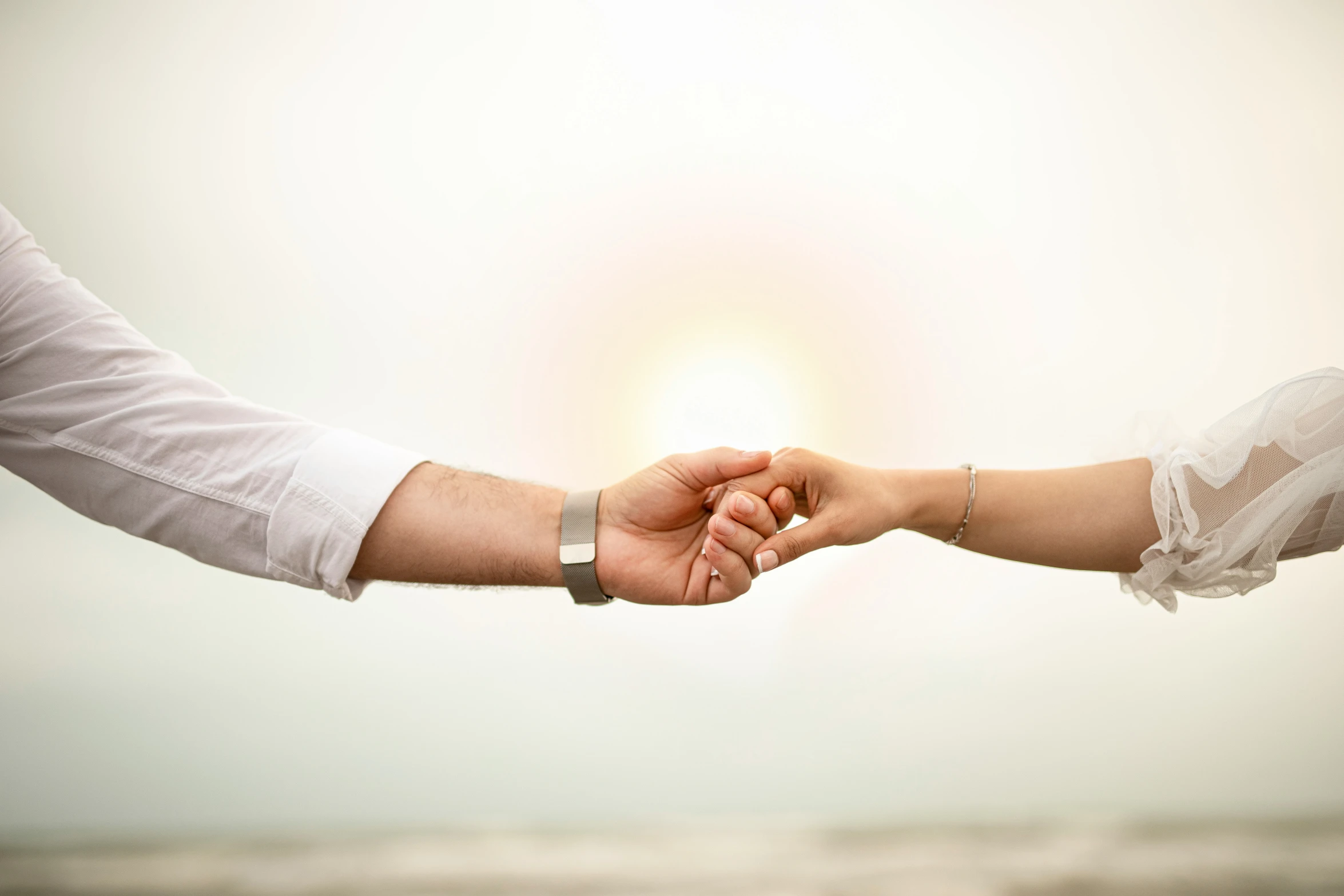 a man and a woman holding hands, one being held by another