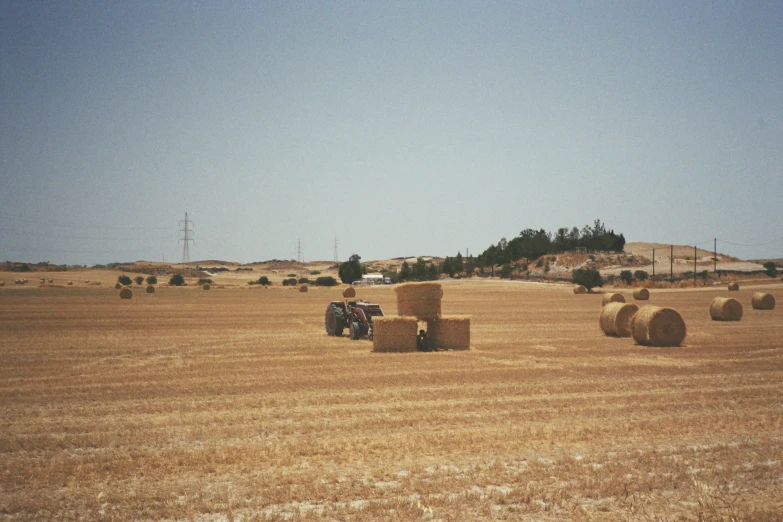 two people ride in a vehicle down a large field