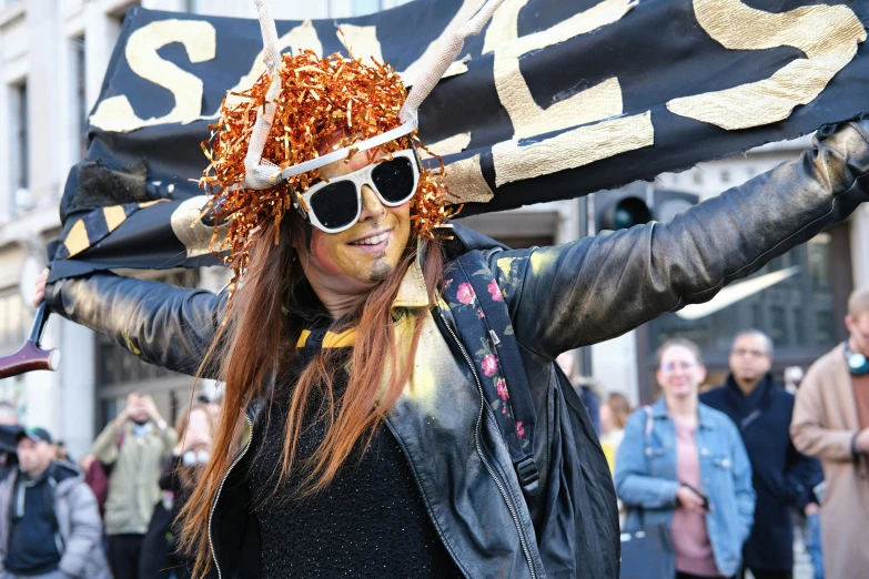 a woman is dressed in costume as she holds a large banner