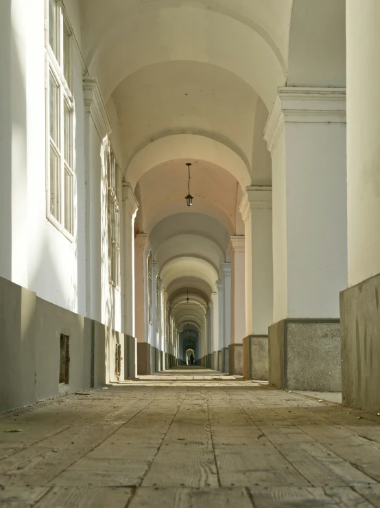 a narrow corridor in a building with an empty floor