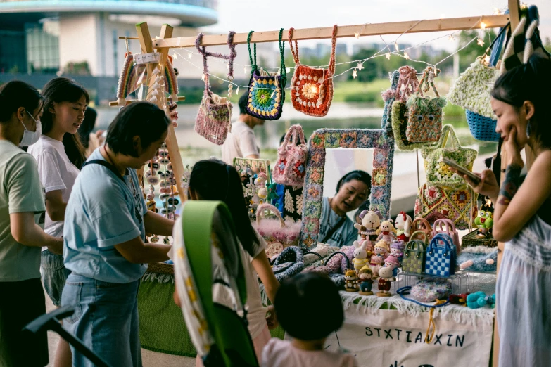 people standing around an exhibit display of colorful goods