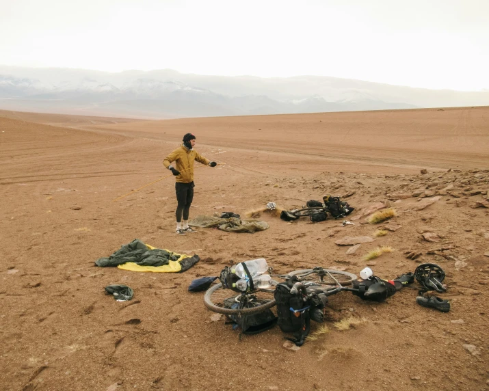 a person in a yellow jacket and many bags