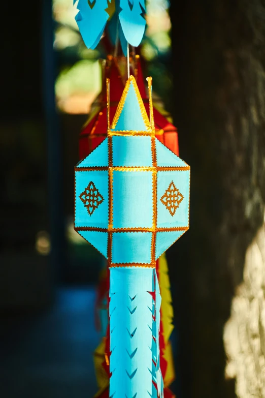 a person's hand holding a decorative item made from paper