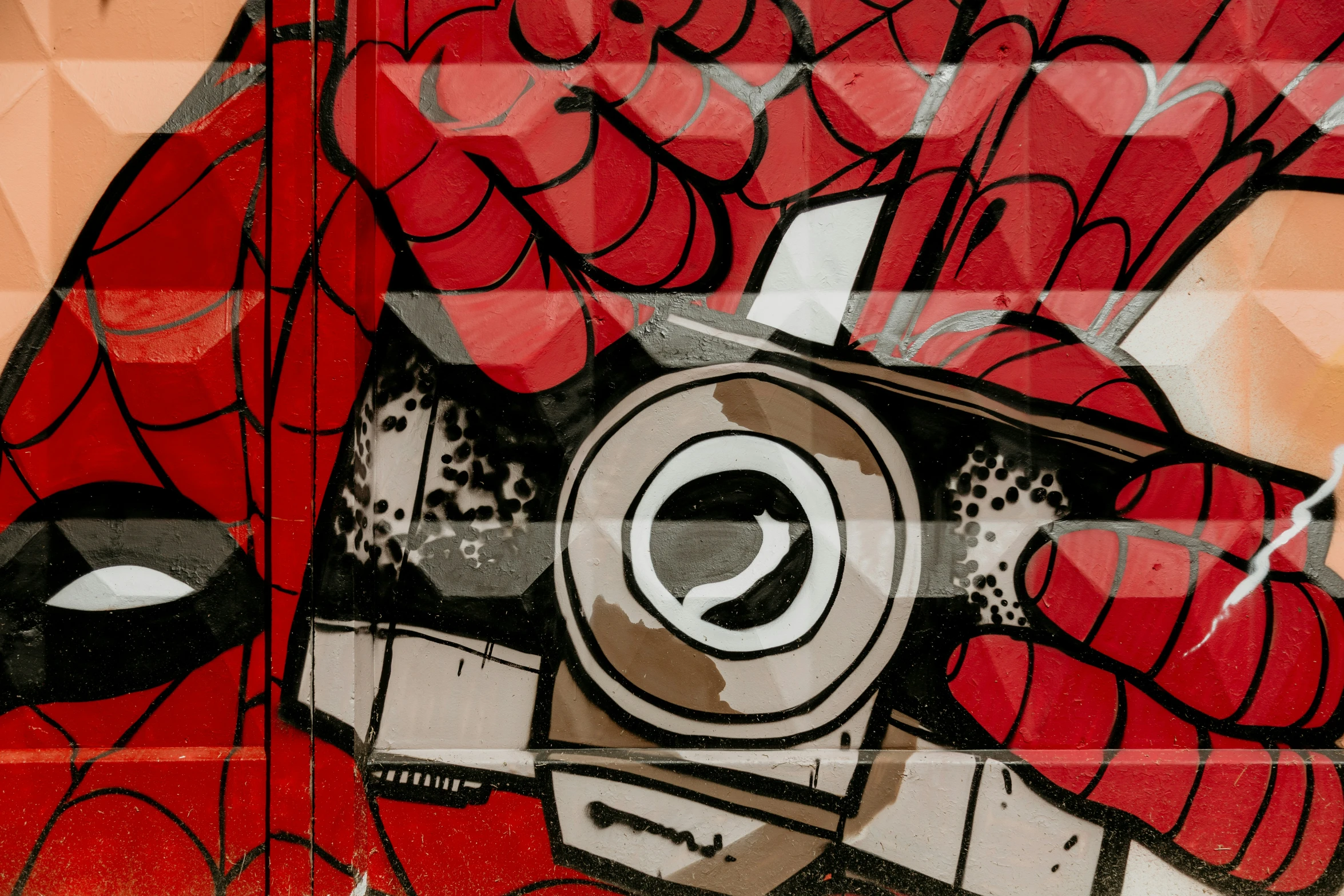 a graffiti artwork shows a red demon and his camera