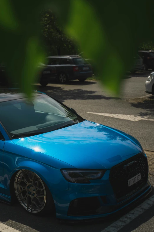 a blue car that is parked outside on the road