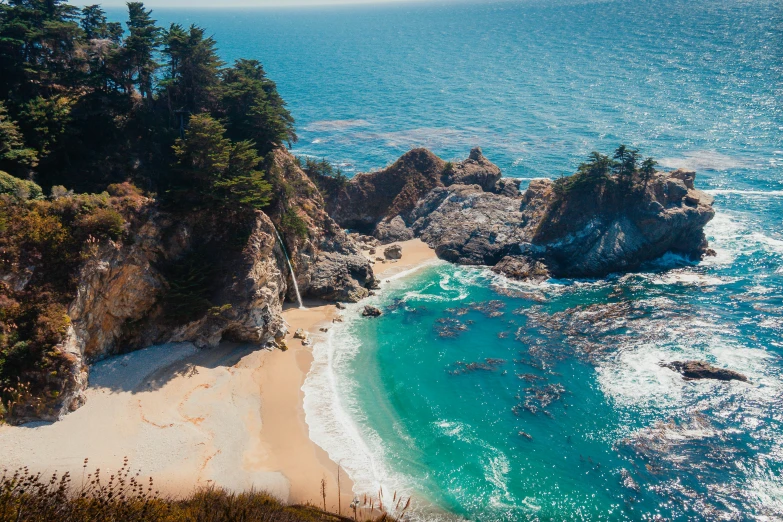 the beach is clear and blue and is by a cliff