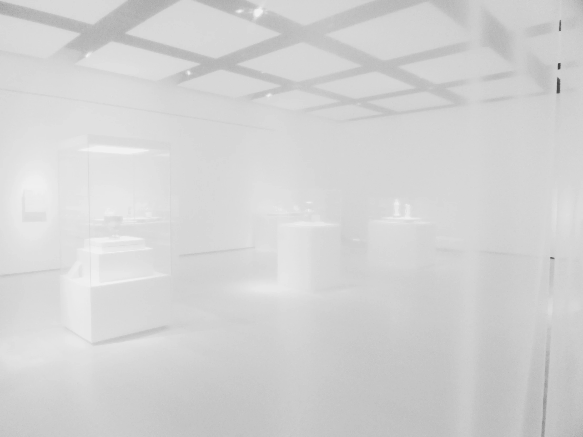 an empty white room with three benches