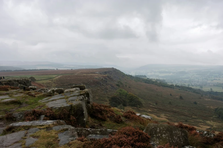 a mountain landscape in the distance with clouds