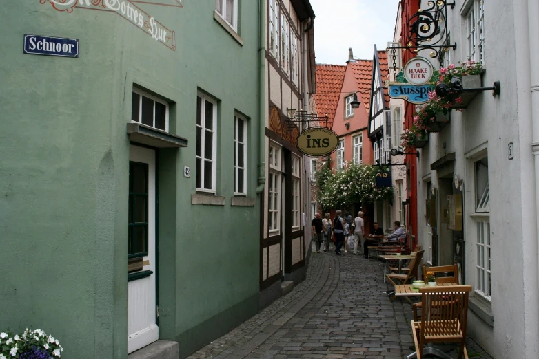 a narrow brick street in front of many small buildings