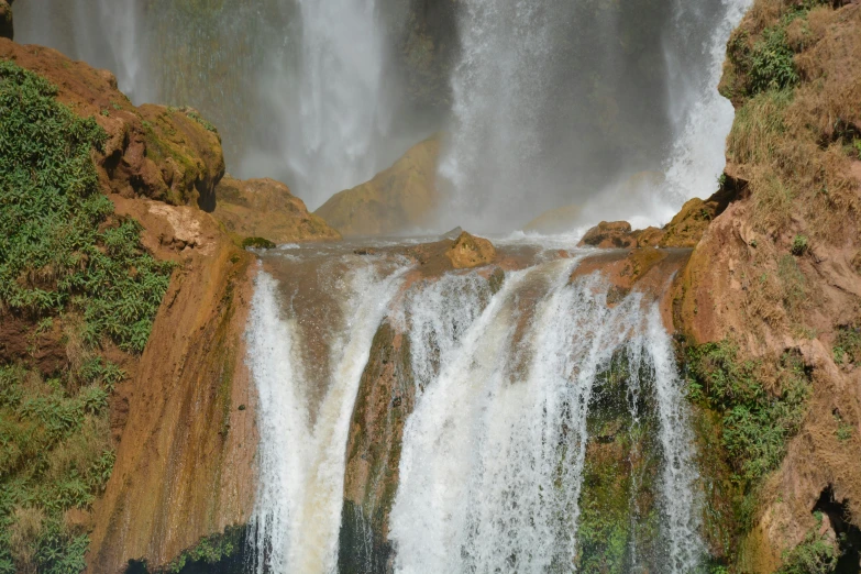 a large waterfall that has water falling off of it